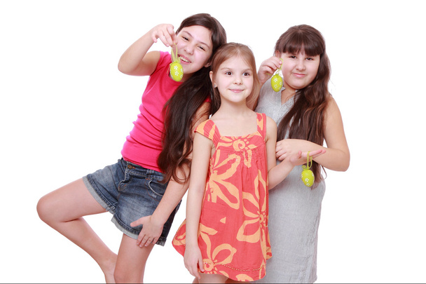 Cheerful little girls holding colorful eggs for Easter - Φωτογραφία, εικόνα