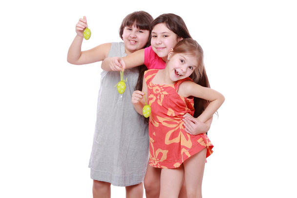 Cheerful little girls holding colorful eggs for Easter - Foto, Imagen