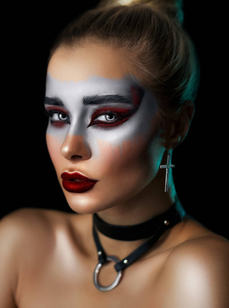 Portrait of young woman with beautiful professional makeup on dark background, closeup - Photo, Image