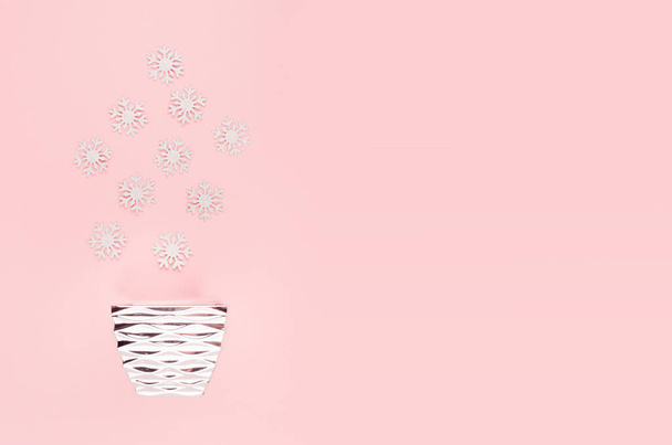 Elegant simple christmas background - silver glittering snowflakes and glossy bowl top view on pastel pink backdrop. - Photo, Image