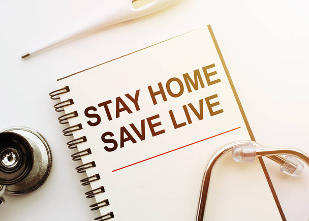 Stay home, save live - text written on notebook to urge to stay at home during the virus. Medical concept. - Valokuva, kuva