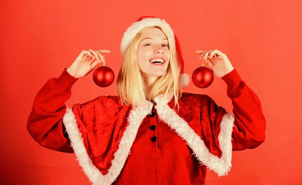 Favorite time year christmas. Merry christmas. Enjoy celebration with proper costume and decoration. Girl happy wear santa costume celebrate christmas hold ball decor. Happy holidays concept - Foto, afbeelding