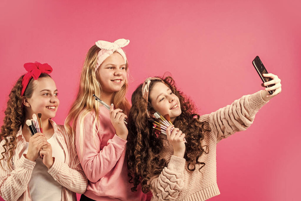 Take selfie. Girls friends have fun beauty salon. Children with make up and healthy skin. Happy childrens day. Friends sisters doing makeup. Makeup skills. Female beauty routine. Womens day - Fotografie, Obrázek