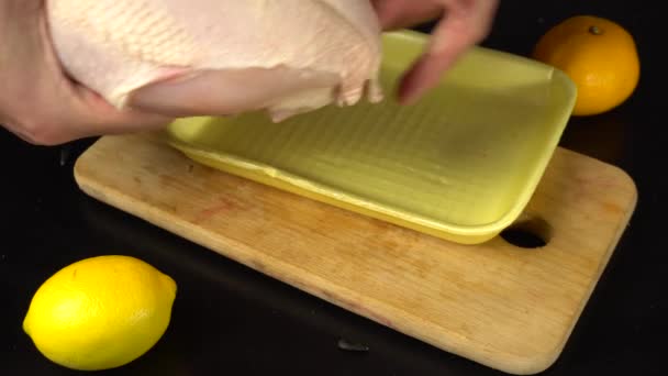 Dietary nutrition, a man puts and cuts the meat chicken breast to cook steak, protein food for the athlete - Footage, Video
