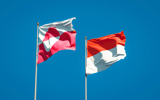 Hermosas banderas estatales nacionales de Groenlandia e Indonesia juntas en el fondo del cielo. Concepto de obra de arte 3D.  - Foto, Imagen