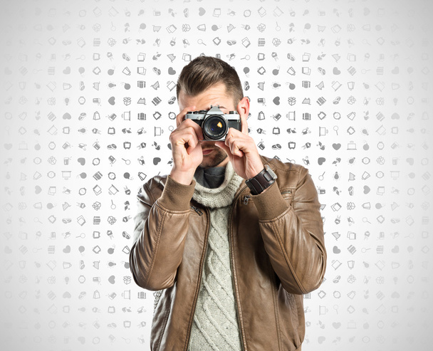 Uomo fotografare qualcuno su sfondo icone
 - Foto, immagini