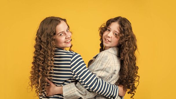 happy girls with long windy hair. healthy and strong hair. hairdresser beauty salon. Nice and tidy hairstyle. sisters active kids with long gorgeous hair. Extra fresh dry shampoo - Valokuva, kuva