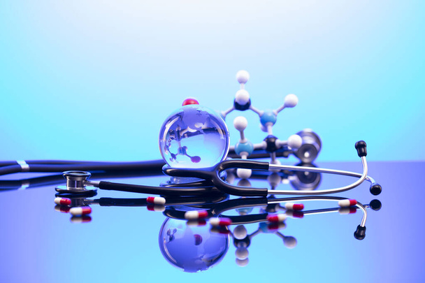 Concepto de salud. Estetoscopio y medicamentos. Mesa azul y fondo. - Foto, imagen