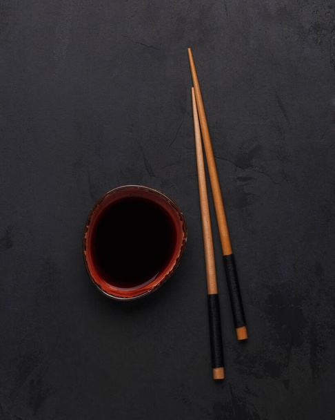 Roll sticks and soy sauce. Asian and Thai cuisine. Soy sauce sticks on a black background - Foto, Imagen