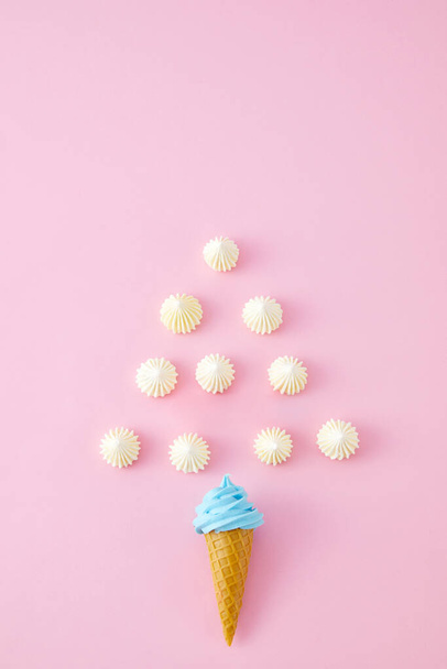 A top view closeup of swirled marshmallows, skittles and ice cream cones isolated on a pink background - Valokuva, kuva