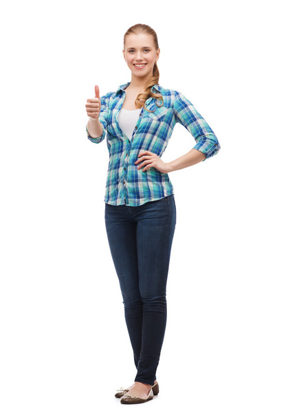 Young woman in casual clothes showing thumbs up - Fotó, kép