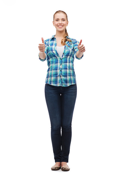 Young woman in casual clothes showing thumbs up - Foto, immagini