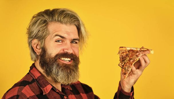 hungry man eating pizza. fast food Delivery. eating delicious cheesy pizza. happy bearded man italian food. italy is here. Cooking food concept. giving food order and holding pizza - Valokuva, kuva