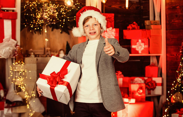 Shopping of his dreams. visit santaland this holiday. winter wonderland in north pole. small boy celebrate new year in residence of santa. best xmas gift. teen boy help santa with presents - Foto, Bild