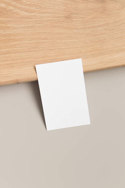 White business card mockup 85x55mm on a beige table. - Fotó, kép