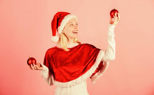 Girl happy wear santa costume celebrate christmas hold ball decor pink background. Merry christmas and happy new year. Christmas preparation concept. Lets have fun. Favorite time year christmas - Photo, image