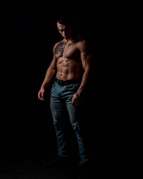 Sport and workout. Man with muscular body. Athletic bodybuilder pose - 写真・画像