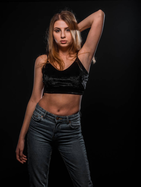 Studio body shot of an attractive woman posing in stylish clothes - Foto, Bild