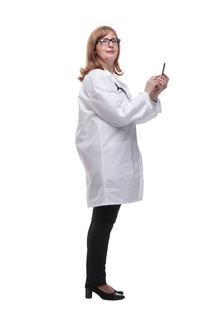 side view. qualified female doctor using her smartphone - Foto, Bild