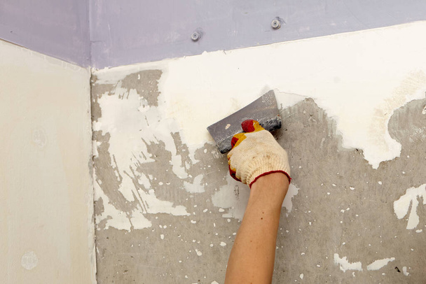 Répare le mur. Plâtrez le mur avec une spatule. Travaux de construction et de finition internes.  - Photo, image