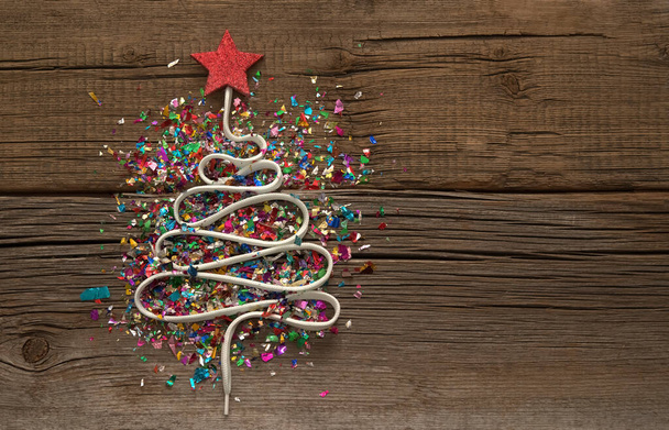 Christmas Tree from a lot colorful confetti, lace and  star toy on  wooden background. Empty copy space for inscription. Idea of  new year 2021 holiday - Zdjęcie, obraz