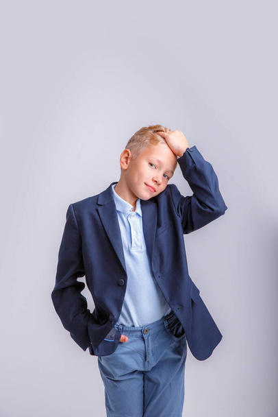 boy with jacket on his head on grey background. - Foto, imagen