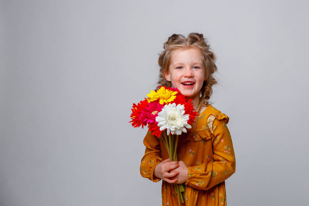 portrait of cute girl with bouquet of flowers white background  - Photo, image