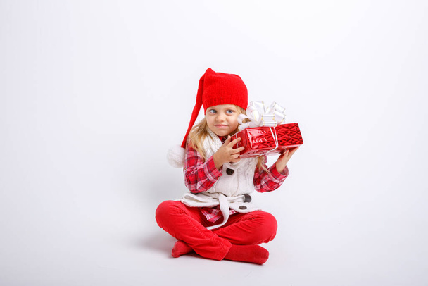adorable kid posing in studio with christmas gift - Photo, Image