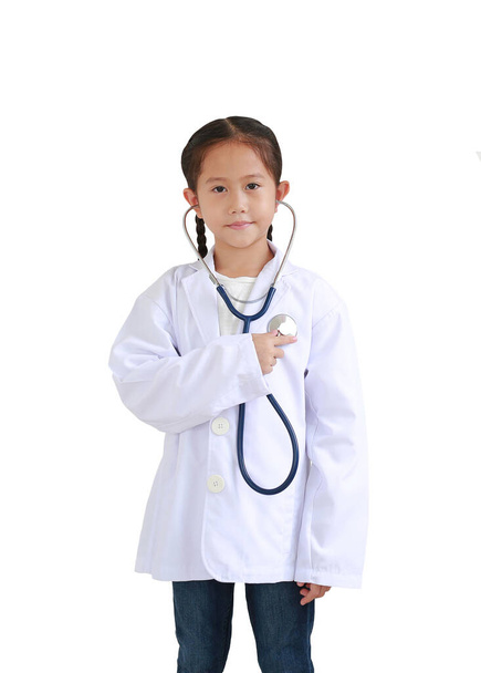 Portrait little asian kid girl with stethoscope while wearing doctor's uniform isolated over white background - Foto, immagini