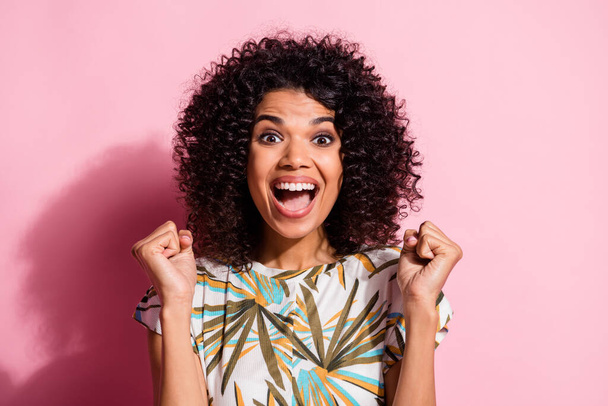 Photo portrait of woman screaming celebrating victory with fists up isolated on pastel pink colored background - Photo, Image