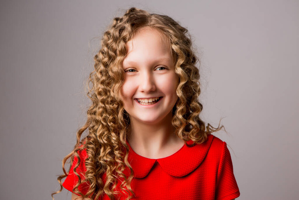 blond little girl in red dress in studio  - Fotografie, Obrázek