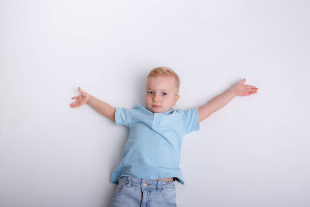 cute baby boy in a gray shirt. studio portrait - Fotoğraf, Görsel