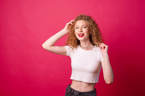 portrait of a young woman posing on pink background - Photo, Image