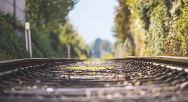 Landscape of an old abandoned railway in fall. Warm light, sustainable traveling - 写真・画像