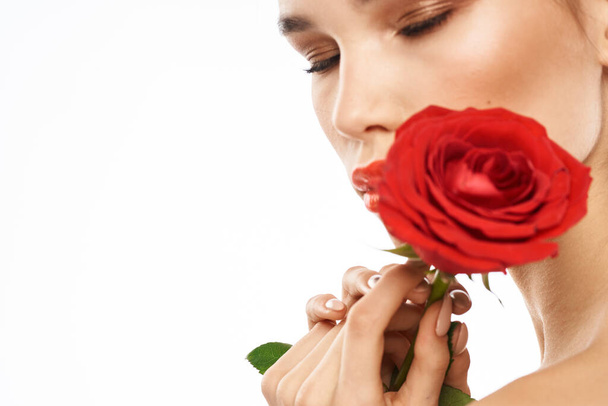 Beautiful woman with red rose near face makeup naked shoulders portrait - Foto, Imagem