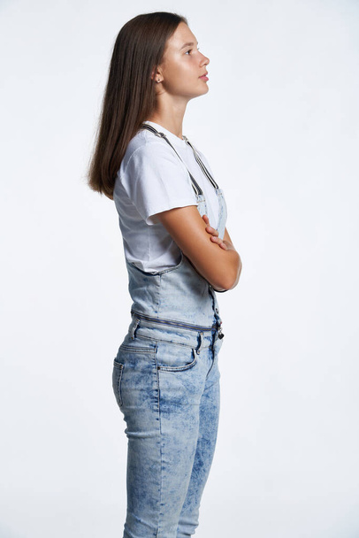 Profile portrait of a teen girl standing looking in front - Foto, Imagem