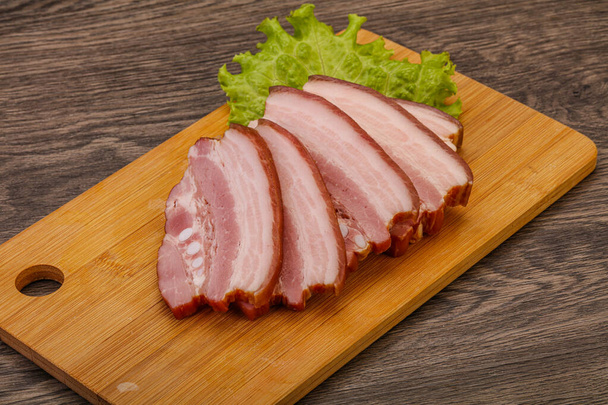 Tasty smoked pork brisket slice over wooden board - Photo, Image