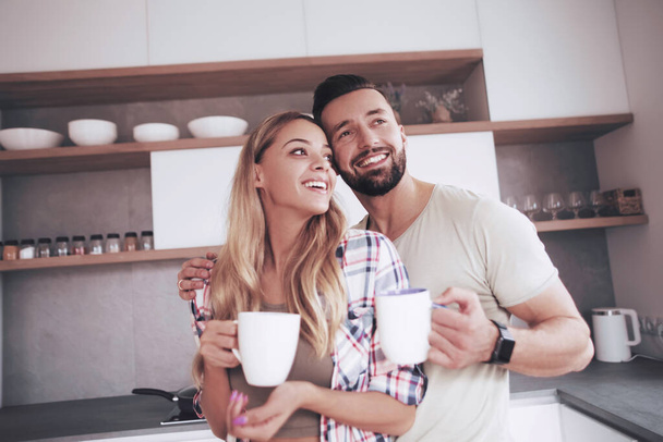young couple in love in the kitchen in a good morning - Photo, image