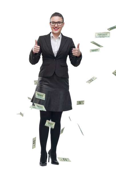in full growth. happy businesswoman standing among dollar bills. - Foto, Bild