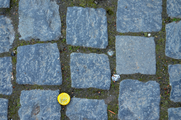 Yelow cap on cobblestone - Photo, Image
