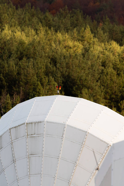 Solar radio telescope hidden in forest nature surveillance spy technology mobile antenna in base beautiful sunny autumn day - Photo, Image