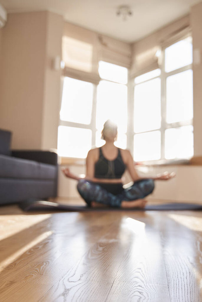 Woman meditating and sitting on lotus pose - Foto, imagen