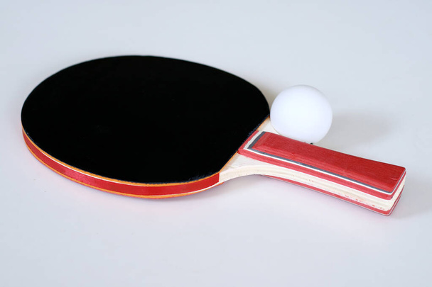Table tennis paddle and ball on white background. - Photo, Image