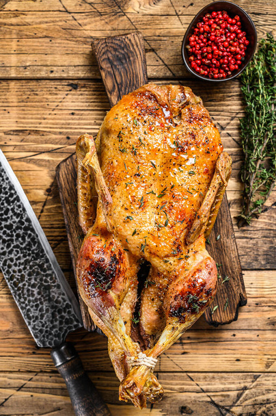 Christmas Baked whole goose with herbs. wooden background. Top view. - Photo, Image