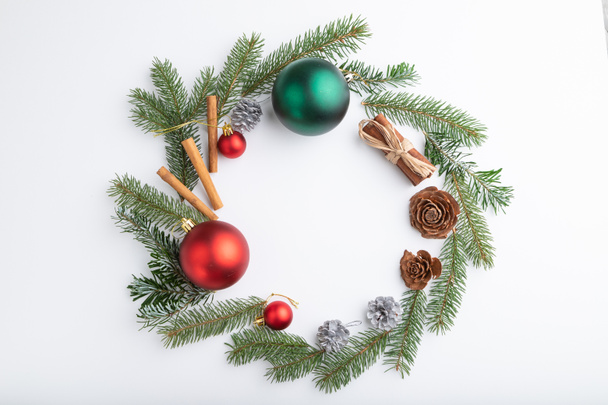 Christmas or New Year wreath composition. Decorations, balls, cones, fir and spruce branches, on white background. Top view, copy space, flat lay. - Φωτογραφία, εικόνα