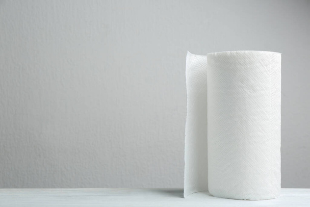 Roll of paper towels on white wooden table, space for text - Fotografie, Obrázek