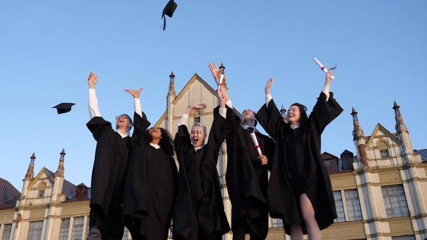 Group of diverse graduation students throwing their mortarboards - Foto, Imagem