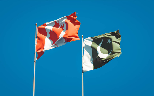空を背景にパキスタンとカナダの美しい国旗が一緒に。3Dアートワークコンセプト.  - 写真・画像