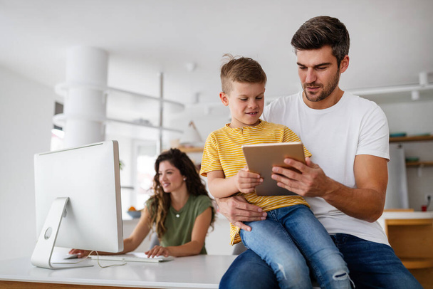 Happy family using technology devices together at home. People, education concept. - Фото, зображення