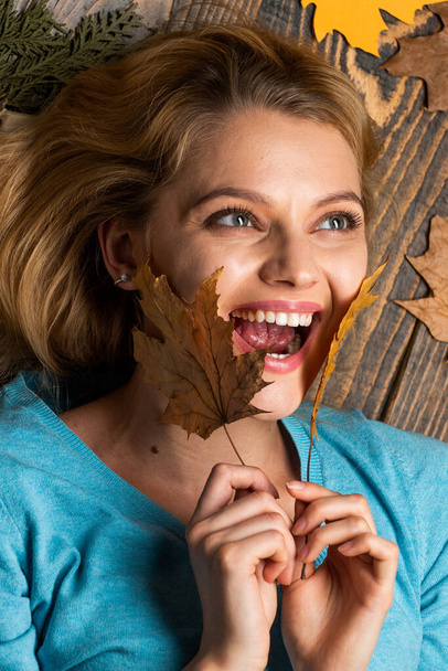 Time to rest. Beauty in autumn style. Sharing love to nature. Staying beautiful any season. autumn female fashion. Carefree and happy. woman hold maple leaf. canada. girl relax on autumn background - Фото, изображение